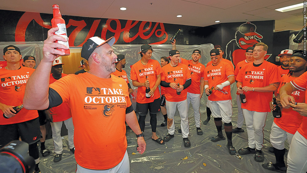 Brandon Hyde leads the celebration after the Orioles clinched a playoff berth